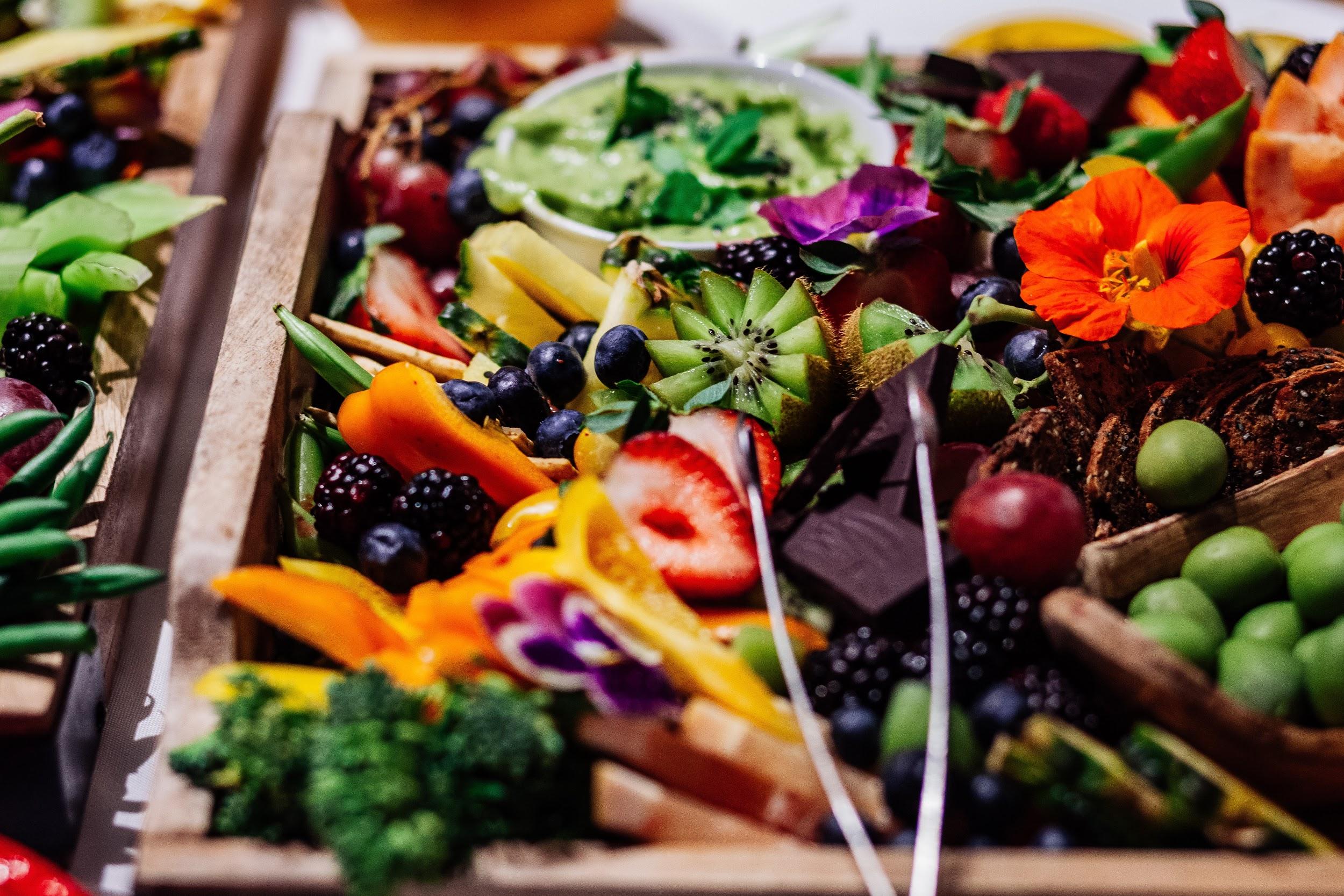 A variety of vegetables are shown on a serving tray