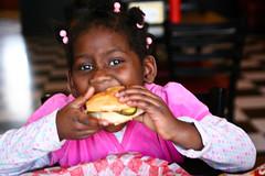 Girl eating hamburger