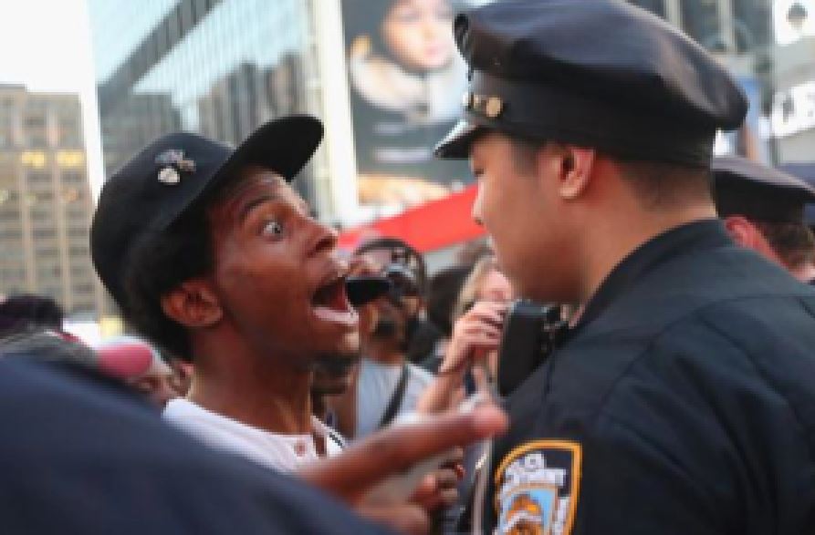 Black man talking to police during Trayvon Martin protests