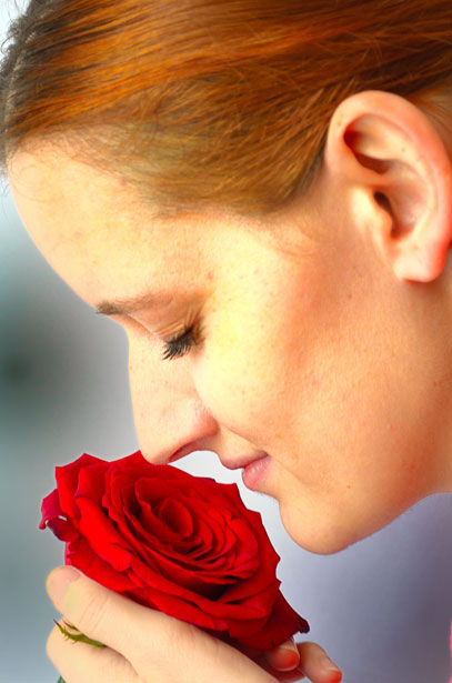 Woman smelling a rose