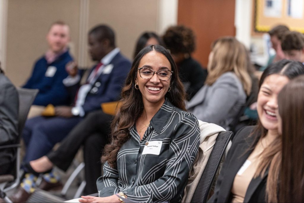 Three women laughing at a business mentoring event.
