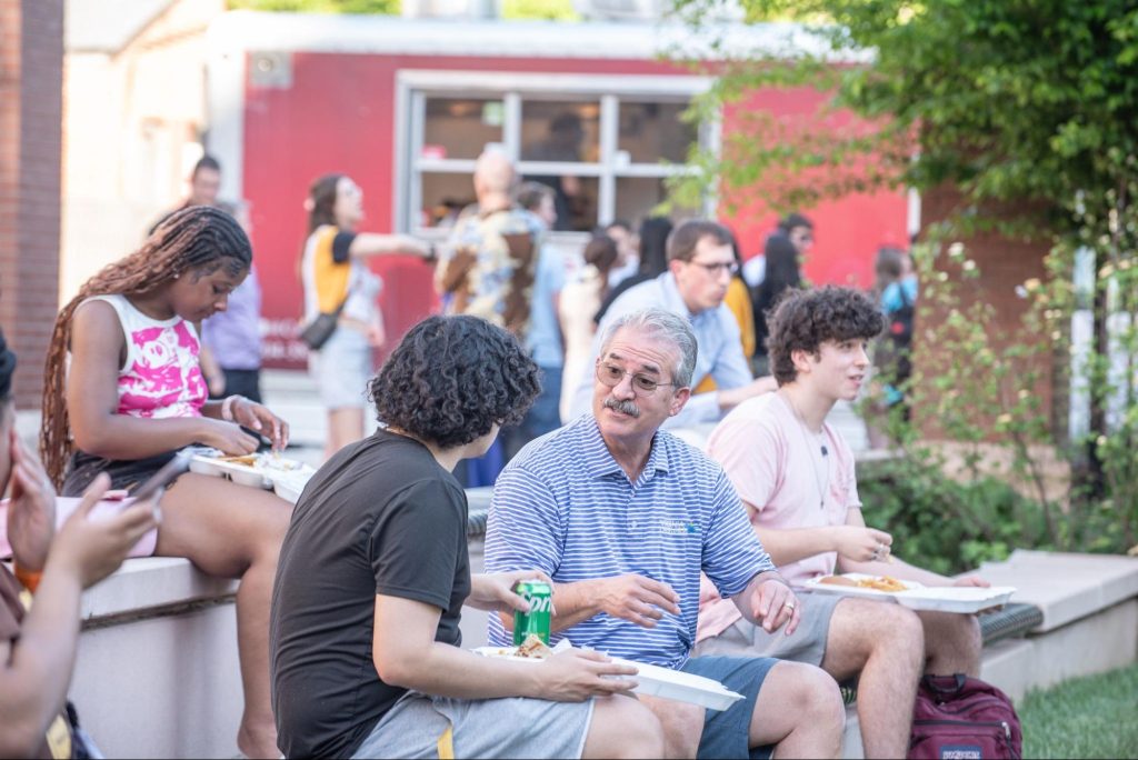 VCU Business Mentoring Mixer 2 An older man and younger man converse outdoors.