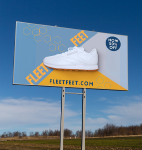 Billboard for Fleet Feet with an image of a white shoe on a blue and white background. Sign reads "Fleet Feet.com Now 50% off"