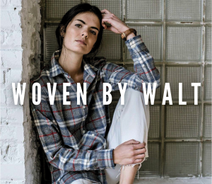 Woman wearing red, white and gray flannel poses against a wall with her head against her hand. Text reads "Woven By Walt" in all caps across the image.