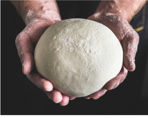 Hands holding a ball of dough