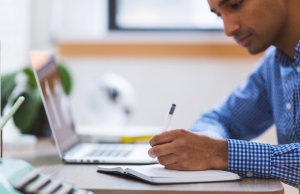 A man taking notes in a notebook