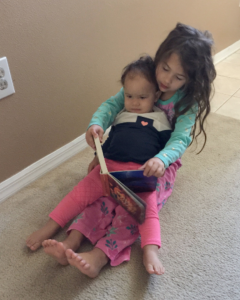 A child reading to a baby