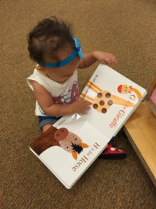 A child reading a book about animals.